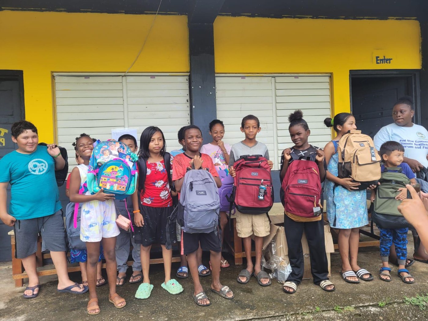 A student holding a new backpack from the Pablo Lambey Foundation